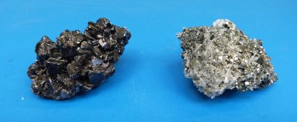 A small geological sample of grey crystals with fools gold scattered between,