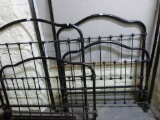 A pair of Victorian black metal and brass single beds