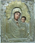 A Russian icon of the Virgin Mary with Jesus in a decorative silver plated frame,