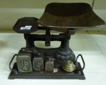 An unusual set of cast iron shop scales with weights to base