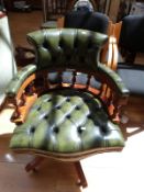 A button back green leather captain's chair