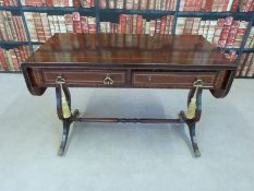 A small mahogany sofa table