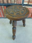A late 19thC / 20thC carved oak Arts and Crafts stool