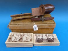 A boxed stereoscope in wooden frame together with a collection of slides including country scenes,