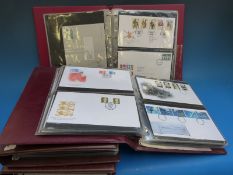 Two albums of GB presentation packs and two albums of first day covers