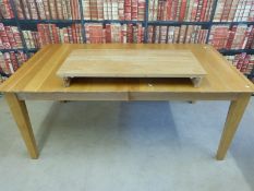 A modern light oak extending dining table (L225 with leaf,
