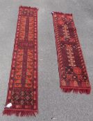 A pair of red ground wool runners with fringed ends (175cm x 33cm,