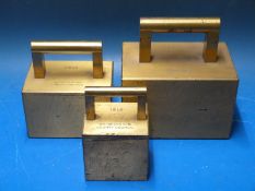 A run of three Warwickshire County Council standard weights, comprising 56lb, 28lb and 14lb.