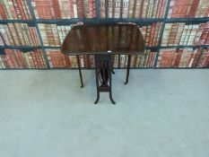 A mahogany line inlaid Sutherland table raised on castors