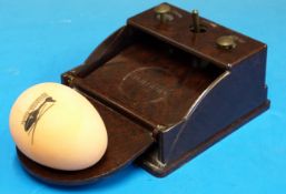 A Bakelite lightning egg grading scale with buttons for first,