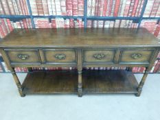 An oak dresser base with three deep drawers with plank base (W176 x D48 x H84cm)