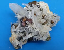 A small geological sample of small partially translucent crystals and one larger crystal,