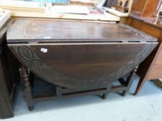 An 18th/19thC oak peg jointed drop leaf table with carved decoration (H72 x W120)