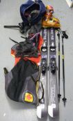 A pair of Salomon skis and boots, both in bags together with Lexi poles,