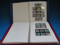 Two albums of Isle of Man and Channel Island stamps