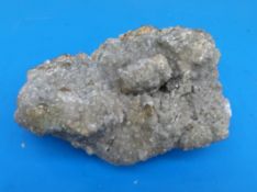 A geological sample formed of dull grey crystals,