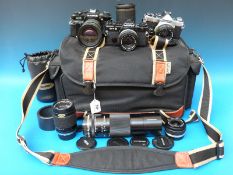 Three Olympus SLR cameras and lenses,