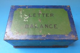 A set of brass postage scales with weights to the wooden base,