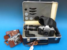 A cased Praktica MTL3 camera with a 300mm telephoto lens and accessories and Hanimex Holiday II