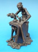 A bronze of a lady at a sewing machine monogrammed JE 76 to base (height 11cm)