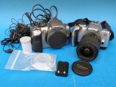 A Canon EOS 300D digital SLR camera body together with an EOS 300 V SLR camera with 28 -90mm lens