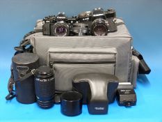 A Canon A-1 camera outfit including various lenses and other accessories,