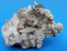 A small geological example of crystals with dark grey stone,