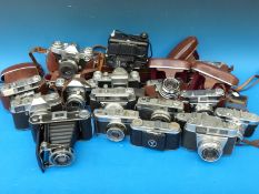 A box of vintage cameras including Zeiss, Ikon, Contaflex,