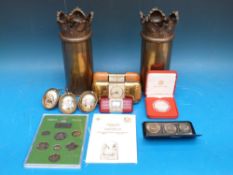 A pair of trench art brass shell cases together with three travelling clocks,