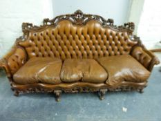 A 19thC style carved walnut and leather sofa and two side chairs (L213cm)