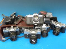 A quantity of SLR cameras comprising two Pentax and three Zenit together with a Zeiss Ikon TLR
