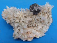 A small geological sample formed of small crystals with large grey sample within,