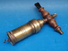 A 19thC brass barrel shaped corkscrew with wooden brush handle