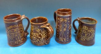 Four Peter Brown 'snake pottery' slip-ware mugs to include a 'toad' mug, a 1977 Jubilee example,
