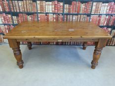 A Cotswold Collection pine kitchen table with substantial turned legs (L183 x W98 x H80cm)