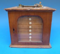 A 19thC pine cabinet of six numbered drawers containing 10 microscope slides each, largely named W.