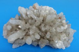 A geological sample formed of large translucent grey crystals,