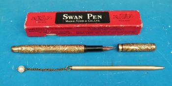 A boxed gilt swan pen with chased decoration,