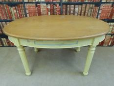 An oval beech kitchen table with single drawer and painted base (L146 x W90 x H77cm)