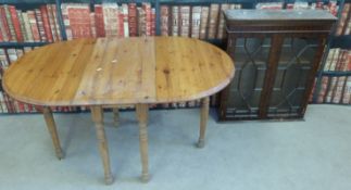 A glazed display cabinet with two shelves together with a pine drop leaf table