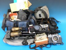 A collection of vintage cameras to include Yashica, some in original cases, together with spares,