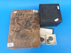 An album of postcards including Scotland, together with carved box,