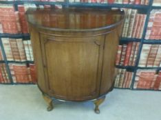 A bow fronted cabinet with two drawers inside,