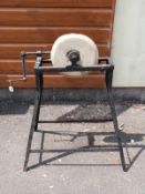 A hand cranked sharpening stone