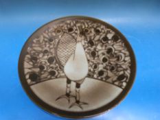 A Poole pottery Aegean number 54 charger, decorated with a peacock, monogrammed to rear R.