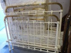 A Victorian brass and cream coloured double bed frame with moulded decoration
