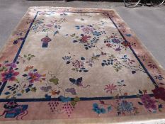 An early 20thC large Chinese rug decorated with urns,