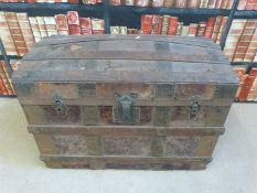 A vintage ash and metal bound domed steamer trunk,