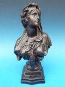 A bronze bust of a lady on stepped base,