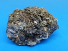 A geological sample of a dark grey and fools gold quartz,